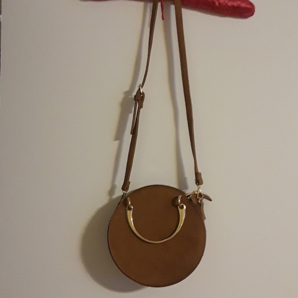 Medium crossbody round faux suede purse.